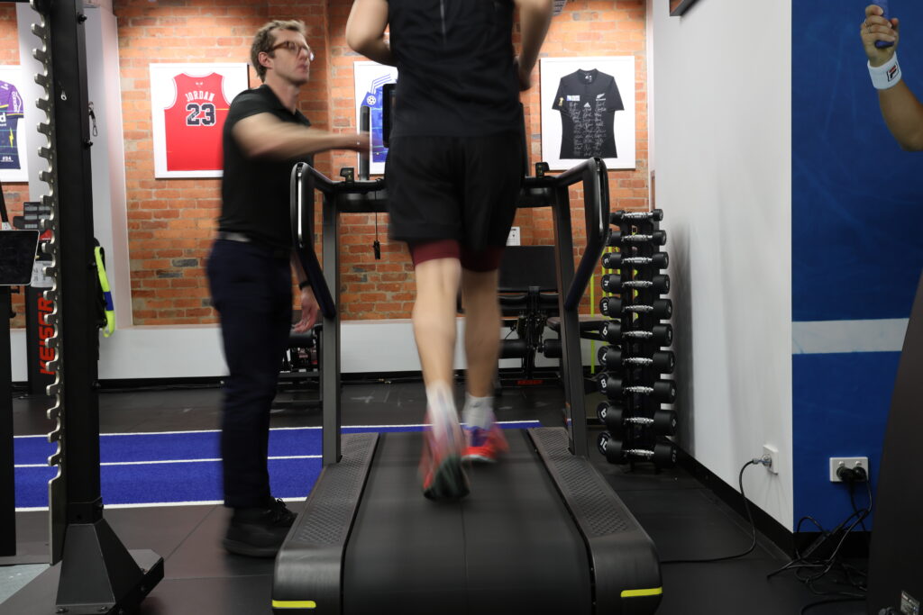 Physiotherapist reviewing video gait analysis results with a runner at Melbourne CBD Physio and Sports Medicine Clinic