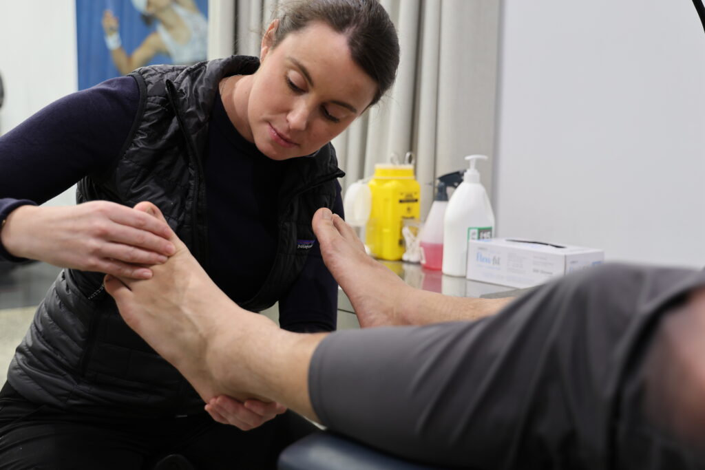 Podiatrist assessing patient foot for orthotic prescription